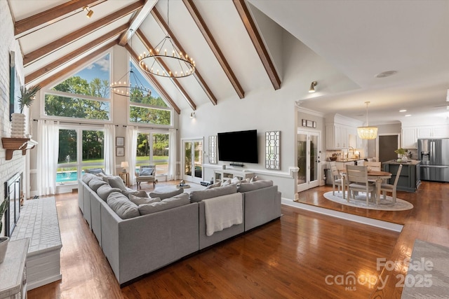 533 Valley Run Dr, Waxhaw, NC 28173 - living area with a chandelier, high vaulted ceiling, beam ceiling, dark wood-type flooring, and a fireplace