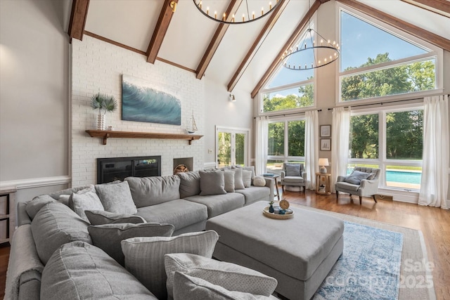 533 Valley Run Dr, Waxhaw, NC 28173 - living area featuring a chandelier, high vaulted ceiling, wood finished floors, beam ceiling, and a brick fireplace