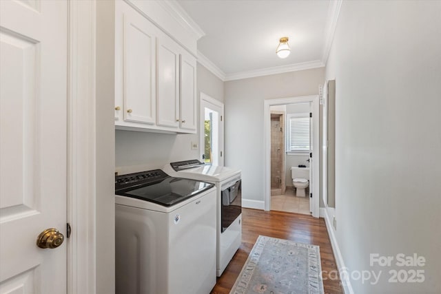 533 Valley Run Dr, Waxhaw, NC 28173 - laundry area with cabinet space, separate washer and dryer, dark wood-style flooring, and crown molding