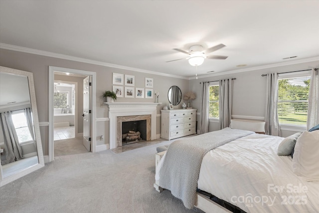 533 Valley Run Dr, Waxhaw, NC 28173 - carpeted bedroom featuring ornamental molding, a premium fireplace, ceiling fan, and ensuite bath
