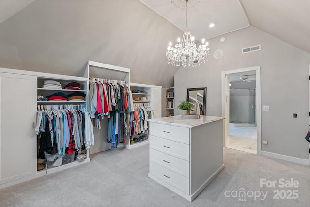 533 Valley Run Dr, Waxhaw, NC 28173 - walk in closet featuring lofted ceiling, light colored carpet, ceiling fan, and a chandelier