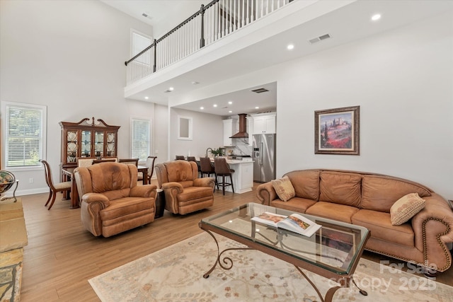 533 Valley Run Dr, Waxhaw, NC 28173 - living area with a towering ceiling, light wood finished floors, and recessed lighting