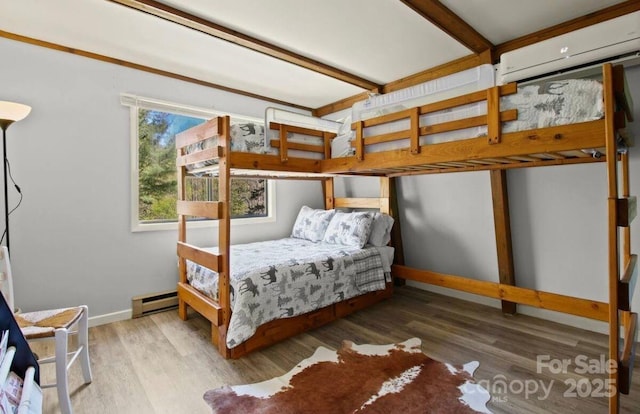26 Pinetop Cir Unit B, Banner Elk, NC 28604 - bedroom with a baseboard heating unit, wood finished floors, and an AC wall unit