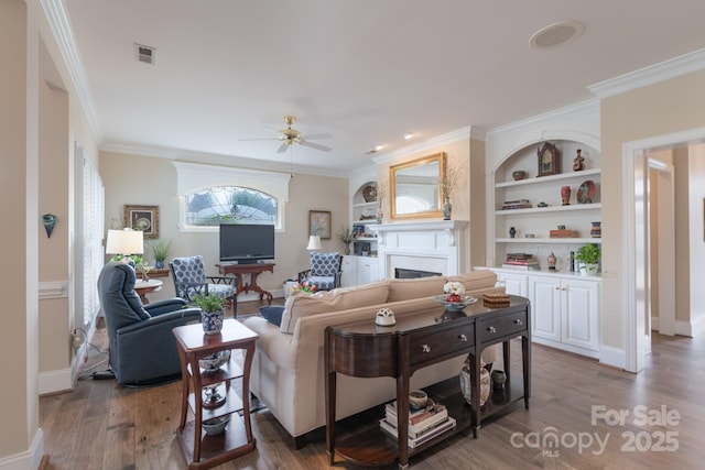 971 Blakeley Walk, Rock Hill, SC 29732 - living room featuring a ceiling fan, a fireplace, wood finished floors, ornamental molding, and built in features