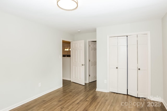 8079 Optimist Club Rd, Denver, NC 28037 - unfurnished bedroom featuring wood finished floors and a closet