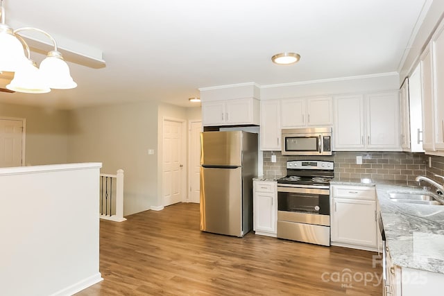 8079 Optimist Club Rd, Denver, NC 28037 - kitchen with stainless steel appliances, white cabinets, backsplash, light wood-style floors, and light stone counters