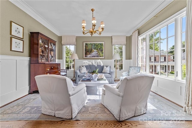 2990 Reynolds Sq, Winston Salem, NC 27106 - living room with a decorative wall, a chandelier, ornamental molding, and wainscoting