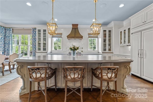 2990 Reynolds Sq, Winston Salem, NC 27106 - kitchen with paneled built in refrigerator, ornamental molding, plenty of natural light, a center island, and white cabinetry