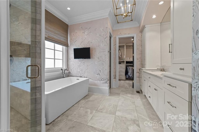 2990 Reynolds Sq, Winston Salem, NC 27106 - bathroom featuring a walk in closet, crown molding, a soaking tub, vanity, and a chandelier