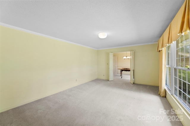 218 Rose St, Mount Holly, NC 28120 - empty room featuring a chandelier, light carpet, and ornamental molding