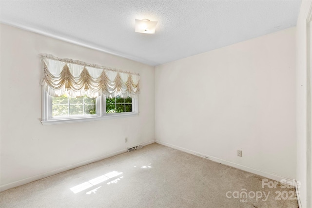 218 Rose St, Mount Holly, NC 28120 - carpeted spare room featuring baseboards and a textured ceiling