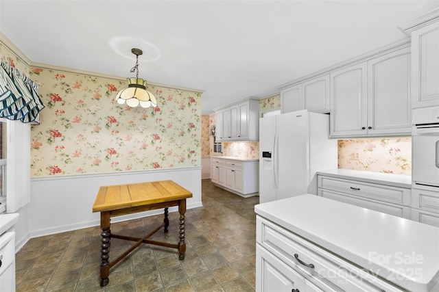 218 Rose St, Mount Holly, NC 28120 - kitchen featuring white appliances, a wainscoted wall, light countertops, wallpapered walls, and white cabinets