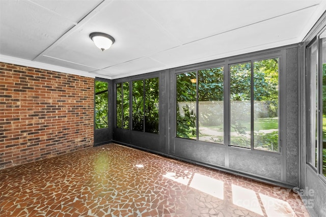 218 Rose St, Mount Holly, NC 28120 - unfurnished sunroom featuring healthy amount of natural light and brick wall