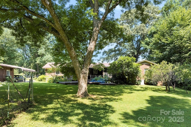 218 Rose St, Mount Holly, NC 28120 - view of grassy yard featuring a carport