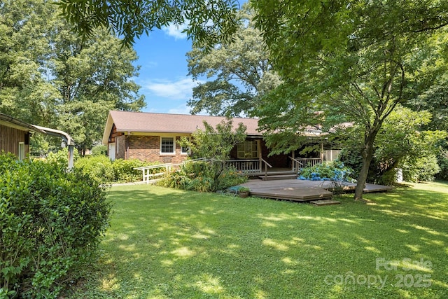 218 Rose St, Mount Holly, NC 28120 - rear view of property with brick siding, a lawn, and a wooden deck