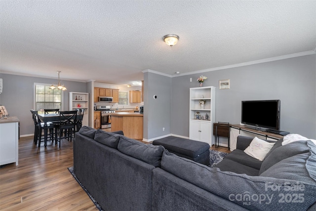 108 W Welsh St, Kershaw, SC 29067 - living area with light wood finished floors, a textured ceiling, crown molding, and a chandelier