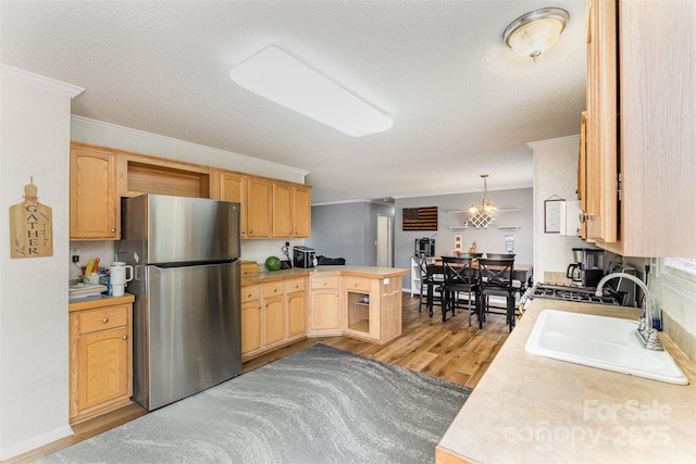 108 W Welsh St, Kershaw, SC 29067 - kitchen with freestanding refrigerator, crown molding, a peninsula, light countertops, and a textured ceiling