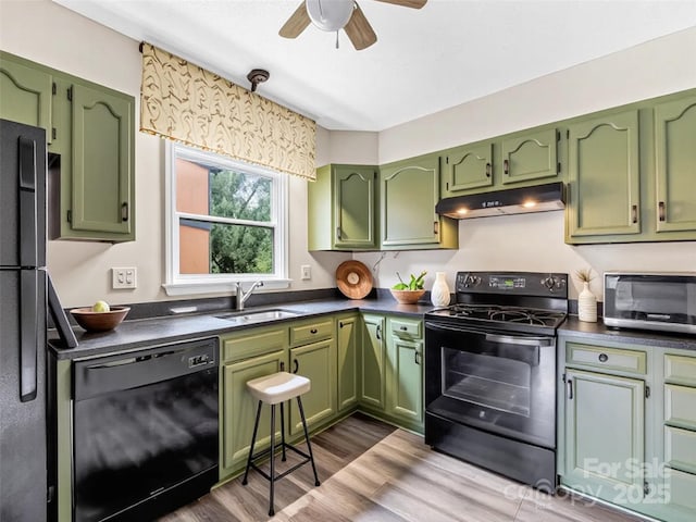 1745 Haywood Manor Rd Unit A, Hendersonville, NC 28791 - kitchen with black appliances, green cabinets, under cabinet range hood, and dark countertops