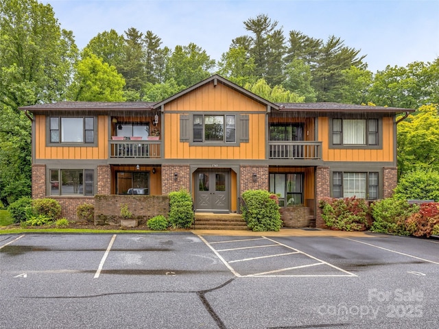 1745 Haywood Manor Rd Unit A, Hendersonville, NC 28791 - view of front of house with a balcony, uncovered parking, and brick siding