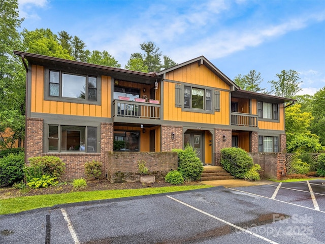 1745 Haywood Manor Rd Unit A, Hendersonville, NC 28791 - view of property with a balcony, brick siding, and uncovered parking