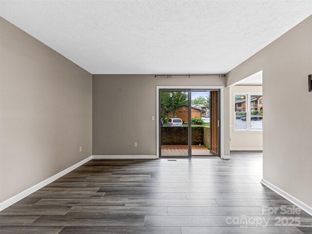 1745 Haywood Manor Rd Unit A, Hendersonville, NC 28791 - unfurnished room featuring dark wood-type flooring and a textured ceiling
