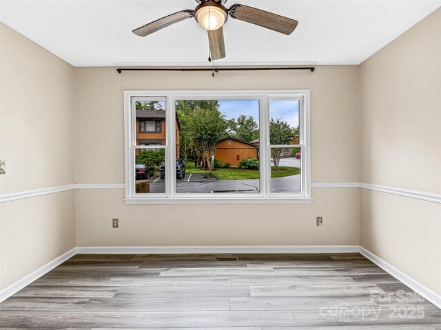 1745 Haywood Manor Rd Unit A, Hendersonville, NC 28791 - unfurnished room with plenty of natural light, a ceiling fan, and wood finished floors