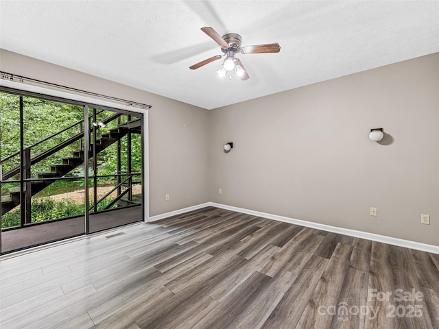1745 Haywood Manor Rd Unit A, Hendersonville, NC 28791 - unfurnished room with dark wood finished floors, a ceiling fan, and a textured ceiling