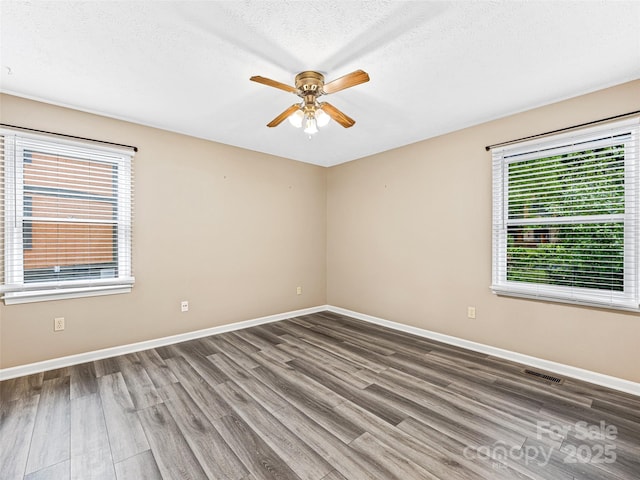 1745 Haywood Manor Rd Unit A, Hendersonville, NC 28791 - unfurnished room with wood finished floors, a ceiling fan, and a textured ceiling