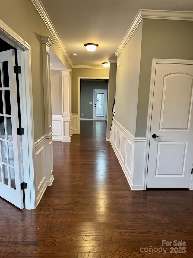 12517 Pine Terrace Ct, Charlotte, NC 28273 - hallway featuring ornamental molding, dark wood-style floors, a decorative wall, a wainscoted wall, and decorative columns