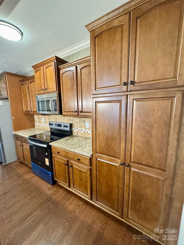 12517 Pine Terrace Ct, Charlotte, NC 28273 - kitchen featuring appliances with stainless steel finishes, dark wood finished floors, backsplash, and brown cabinetry
