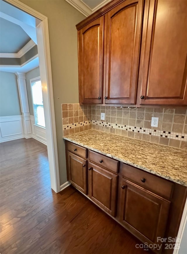 12517 Pine Terrace Ct, Charlotte, NC 28273 - kitchen featuring dark wood finished floors, ornamental molding, decorative backsplash, light stone countertops, and a decorative wall
