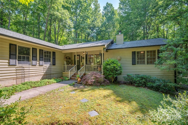 144 Beechwood Dr, Columbus, NC 28722 - ranch-style home featuring a porch, a chimney, and a front yard