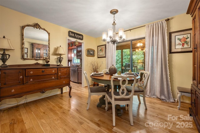 144 Beechwood Dr, Columbus, NC 28722 - dining room with a chandelier and light wood finished floors
