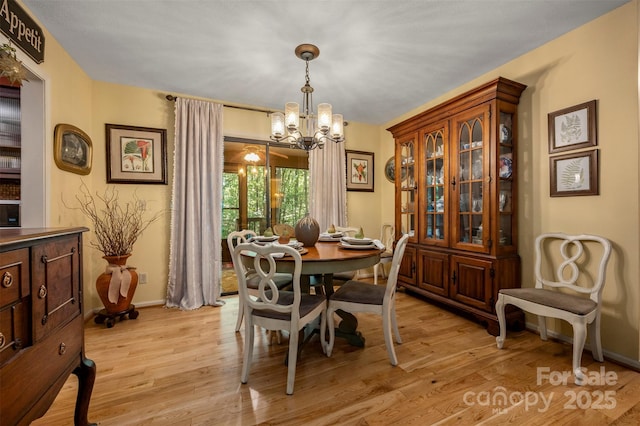 144 Beechwood Dr, Columbus, NC 28722 - dining space with a chandelier and light wood-style flooring