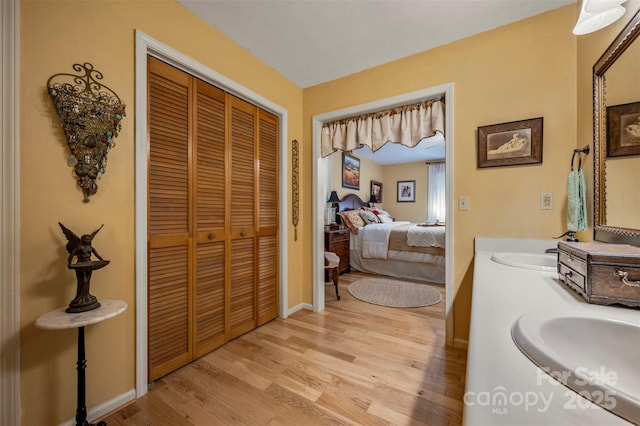 144 Beechwood Dr, Columbus, NC 28722 - bathroom with a closet, double vanity, wood finished floors, and connected bathroom