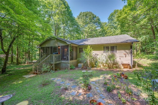 144 Beechwood Dr, Columbus, NC 28722 - view of front of house featuring a sunroom, a front lawn, and roof with shingles