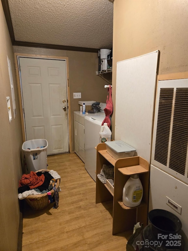 245 Waycross Dr, Rockwell, NC 28138 - washroom with a textured ceiling, light wood-style flooring, and separate washer and dryer