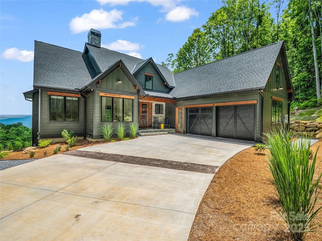 627 Cherry Hl Unit 201, Mill Spring, NC 28756 - view of front of house with driveway, a garage, roof with shingles, board and batten siding, and a chimney