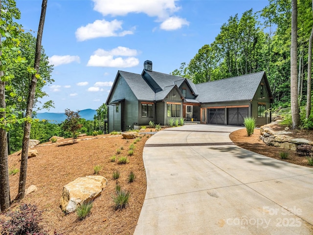 627 Cherry Hl Unit 201, Mill Spring, NC 28756 - view of front of house with concrete driveway, an attached garage, and a chimney
