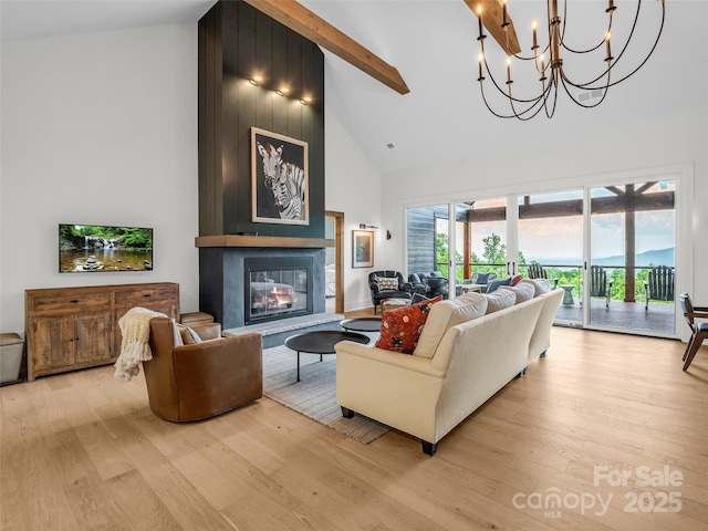 627 Cherry Hl Unit 201, Mill Spring, NC 28756 - living area with high vaulted ceiling, light wood-type flooring, a large fireplace, beam ceiling, and a chandelier