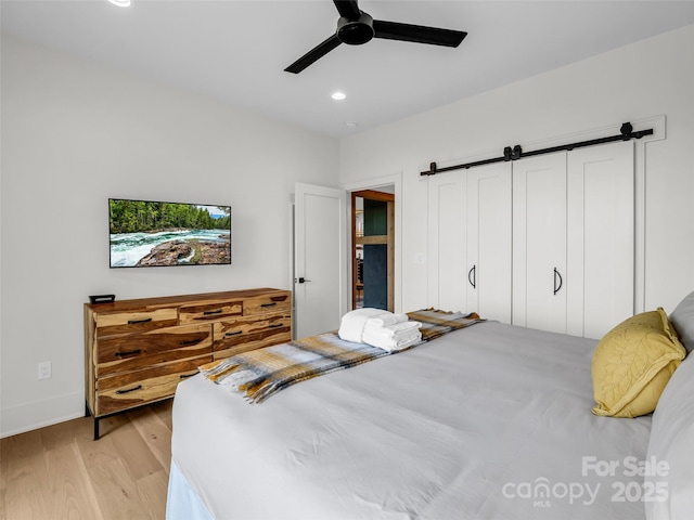 627 Cherry Hl Unit 201, Mill Spring, NC 28756 - bedroom featuring light wood-style flooring, recessed lighting, a barn door, and ceiling fan
