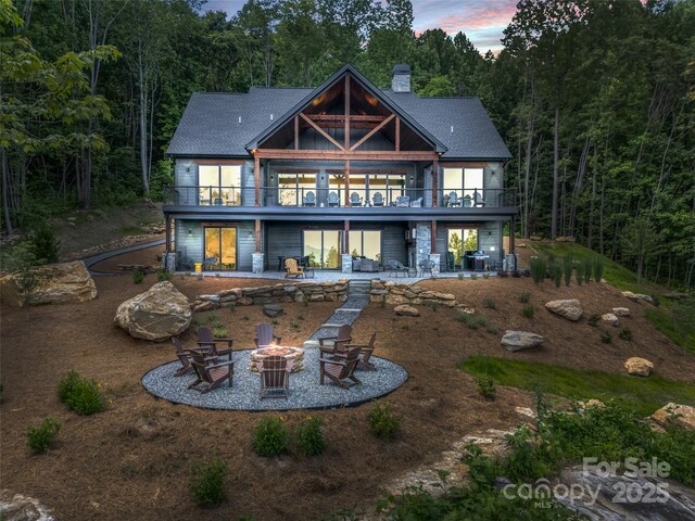 627 Cherry Hl Unit 201, Mill Spring, NC 28756 - rear view of house featuring a patio, an outdoor fire pit, a chimney, and a deck