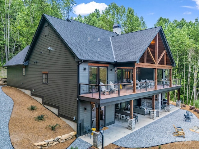 627 Cherry Hl Unit 201, Mill Spring, NC 28756 - rear view of house featuring a shingled roof, a patio area, a chimney, and a deck