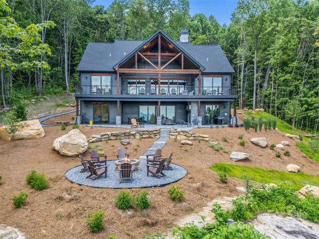 627 Cherry Hl Unit 201, Mill Spring, NC 28756 - back of property with a fire pit, a patio, a chimney, and a wooden deck