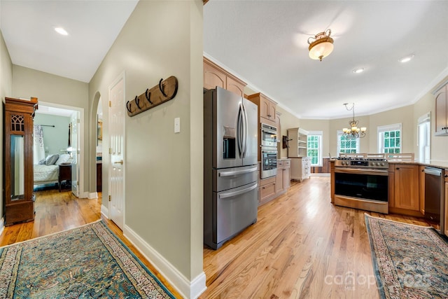 80 Meadow Creek Drive 40 & 61, Weaverville, NC 28787 - kitchen with stainless steel appliances, light wood finished floors, a chandelier, pendant lighting, and a peninsula