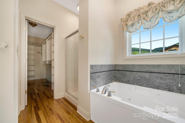 80 Meadow Creek Drive 40 & 61, Weaverville, NC 28787 - bathroom with a spacious closet, a shower stall, wood finished floors, and a tub with jets