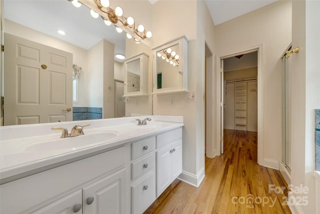 80 Meadow Creek Drive 40 & 61, Weaverville, NC 28787 - bathroom with double vanity, wood finished floors, and a spacious closet