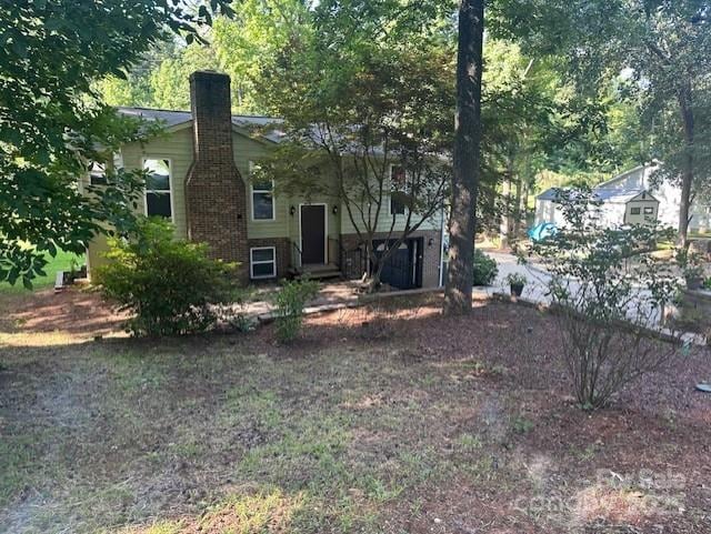 3211 Winding Trl, Matthews, NC 28105 - rear view of property featuring a chimney