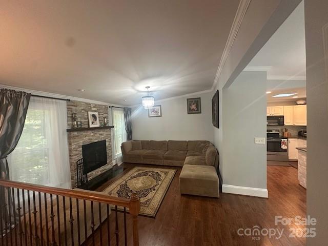 3211 Winding Trl, Matthews, NC 28105 - living area with dark wood finished floors, ornamental molding, and a fireplace