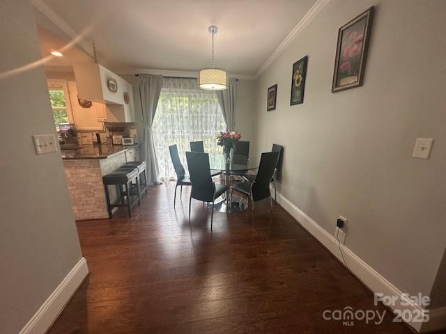 3211 Winding Trl, Matthews, NC 28105 - dining area with dark wood finished floors and ornamental molding